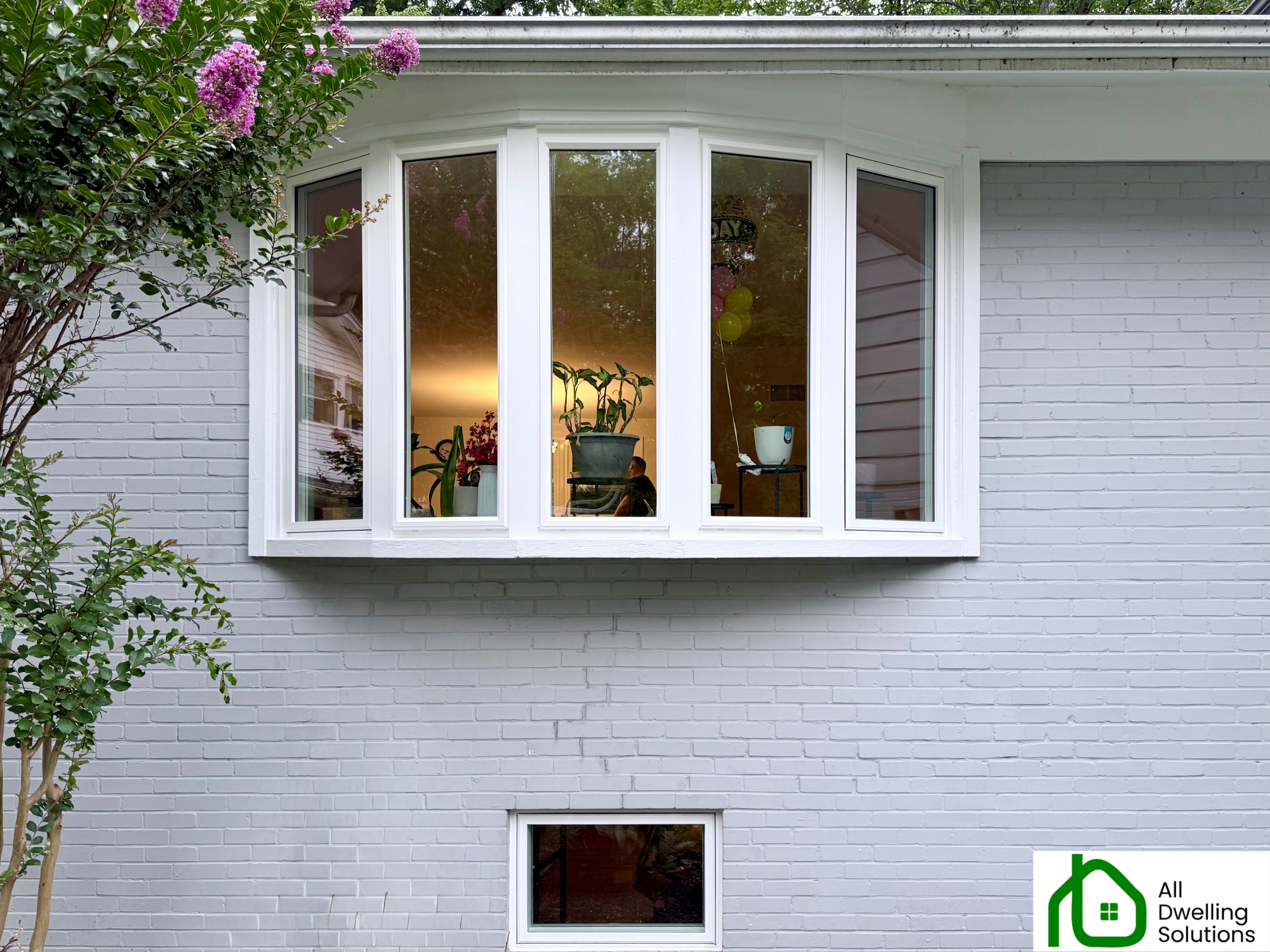 Modern energy-efficient replacement windows installed on a residential home by All Dwelling Solutions, showcasing quality craftsmanship and contemporary window design.
