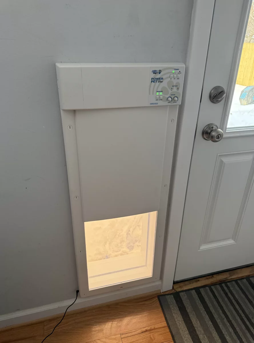 Installed electronic pet door next to an interior door