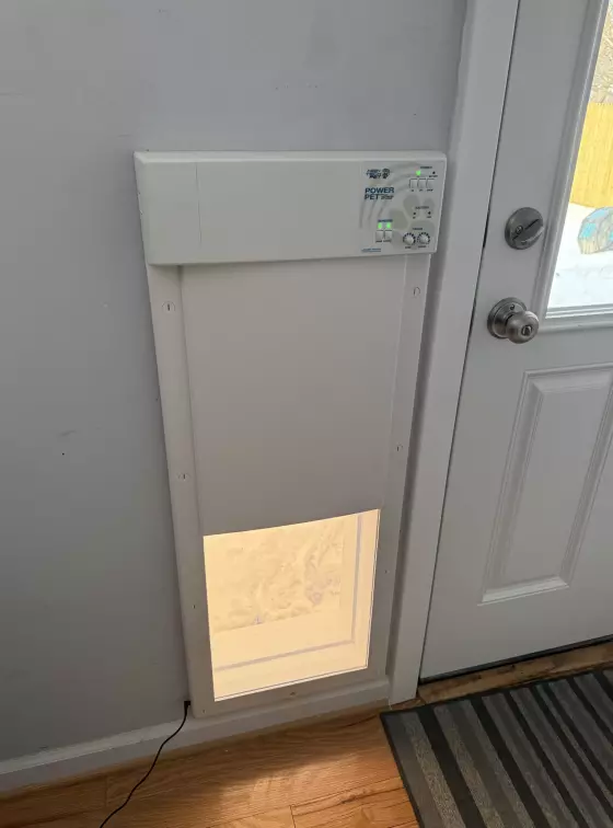 Installed electronic pet door next to an interior door