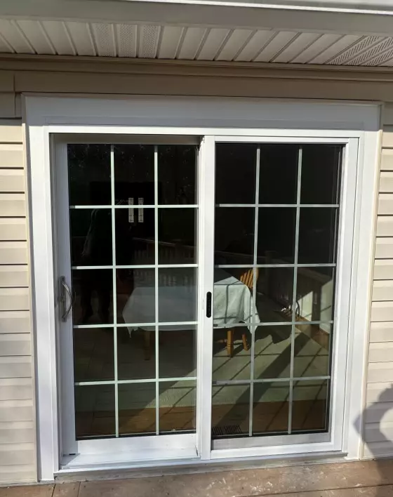 White vinyl sliding patio door with grids inside the glass
