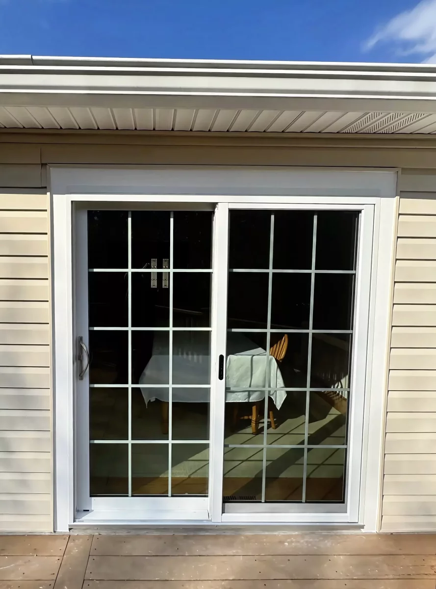 White vinyl sliding patio door with grids inside the glass