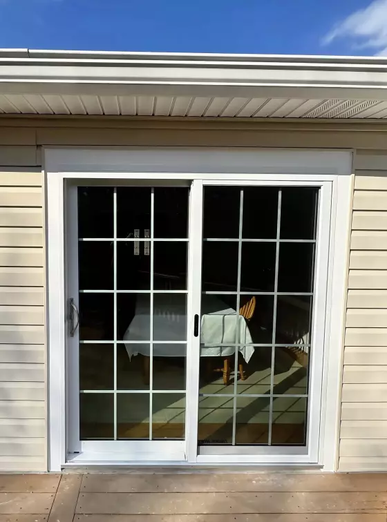 White vinyl sliding patio door with grids inside the glass