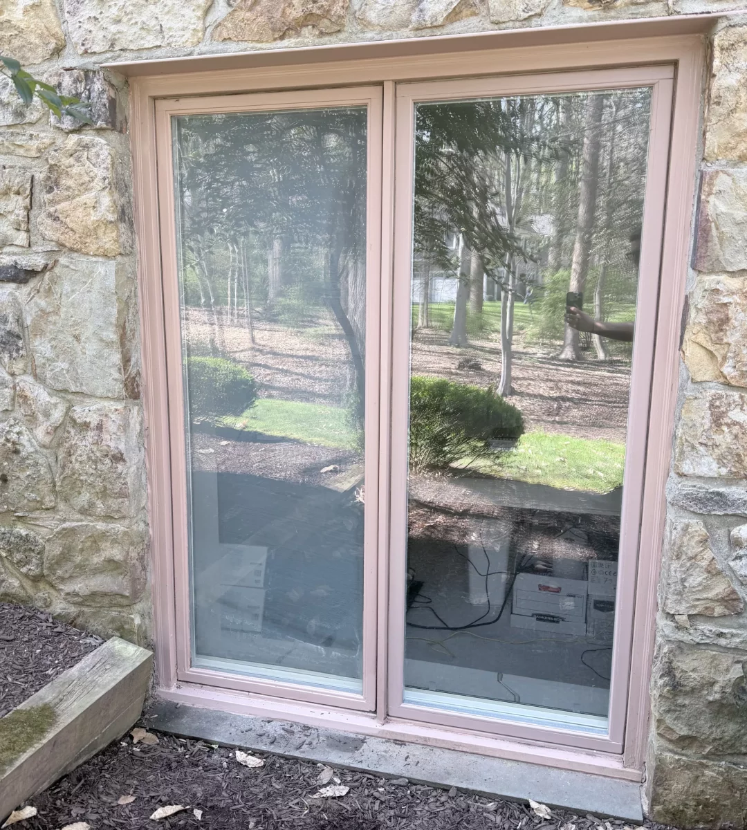 Exterior view of a double-pane window with stone facade