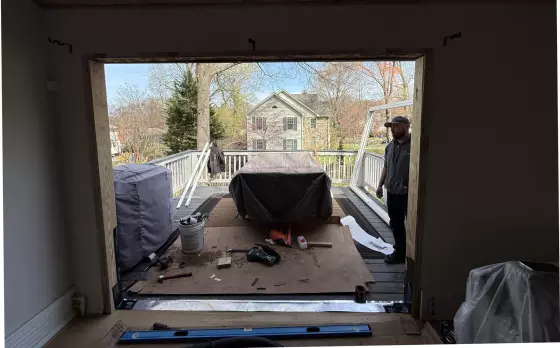 Door opening under construction with tools and worker on deck