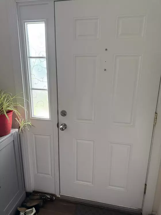 White entry door with side window panel viewed from inside