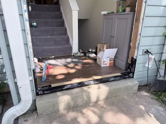 Entry threshold with flashing tape and tools during door installation