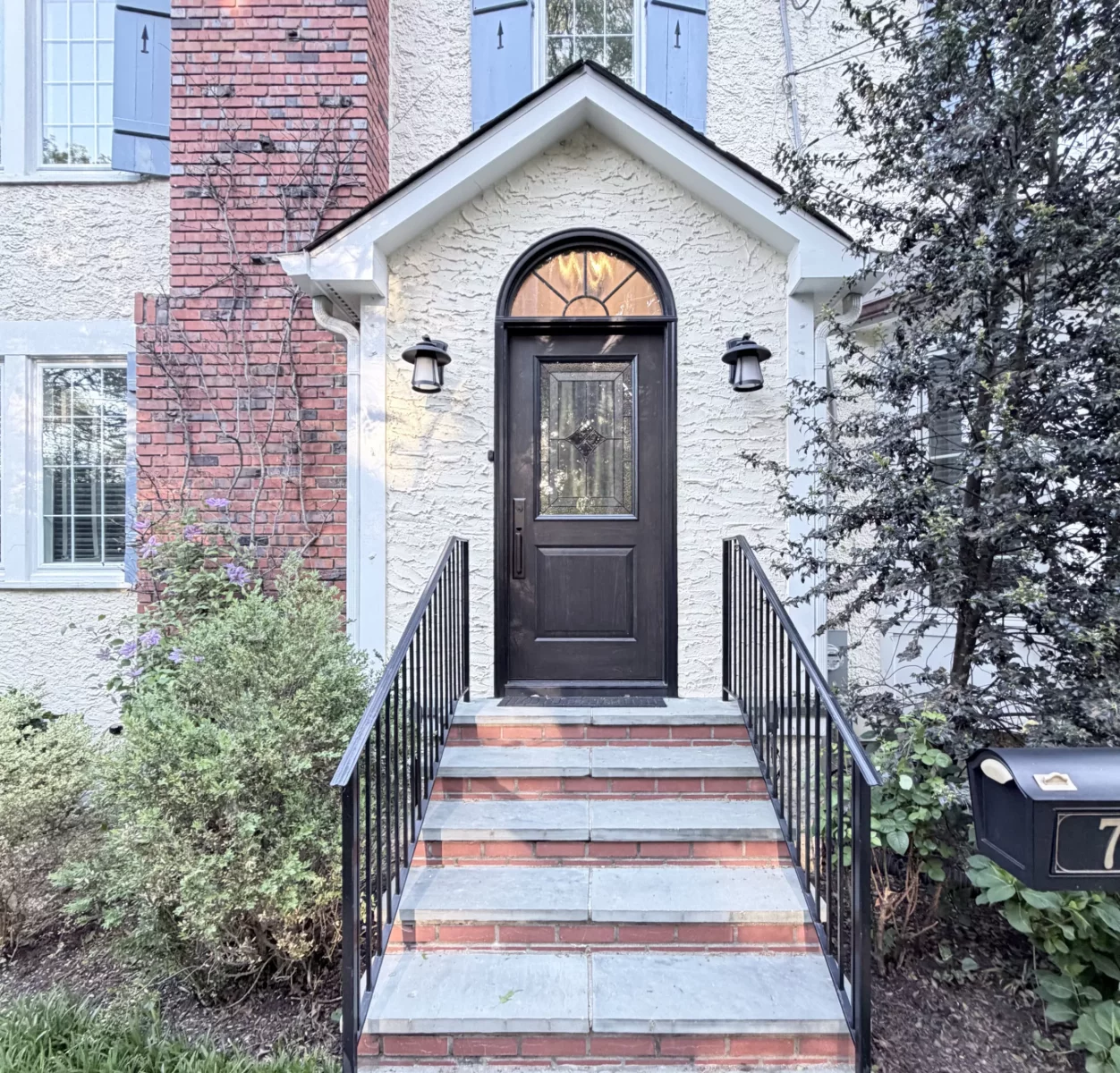 Front entry door with steps and railing on residential home