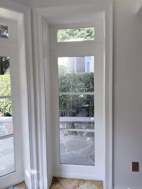 White door with glass panels and trim in a residential interior