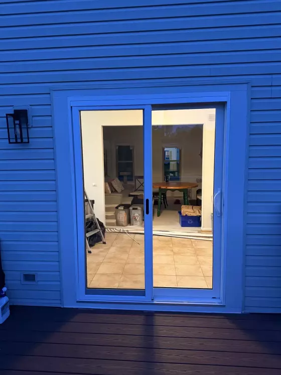 Exterior view of a sliding glass patio door with white frame