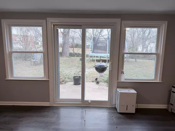 Sliding patio door and two windows in a finished interior room
