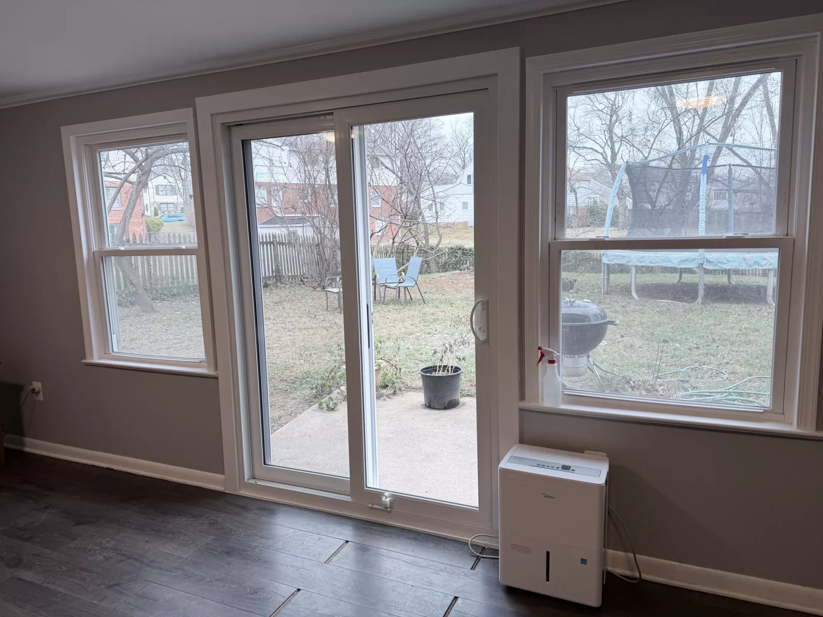 Sliding patio door and two windows in a finished interior room