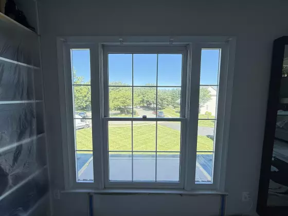Before window replacement showing the original three-section double-hung window configuration in a Rockville, MD home