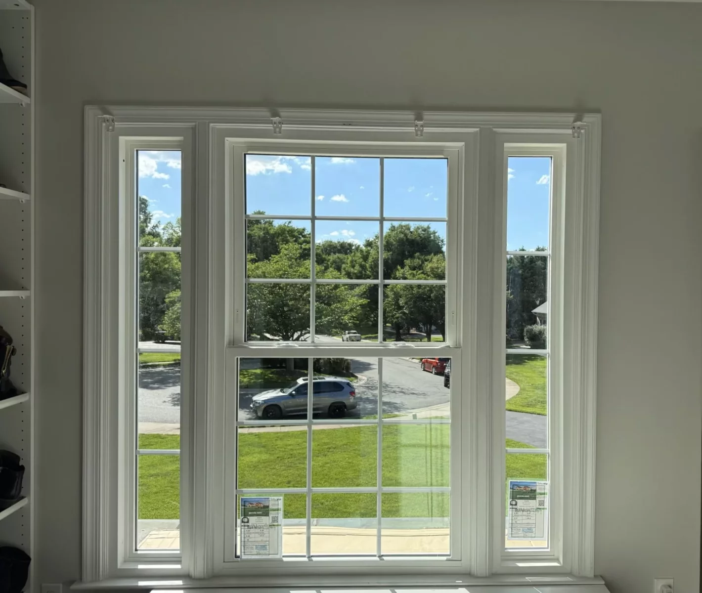 Completed energy-efficient window replacement in Rockville, MD, featuring a double-hung window with grids and two sidelites.
