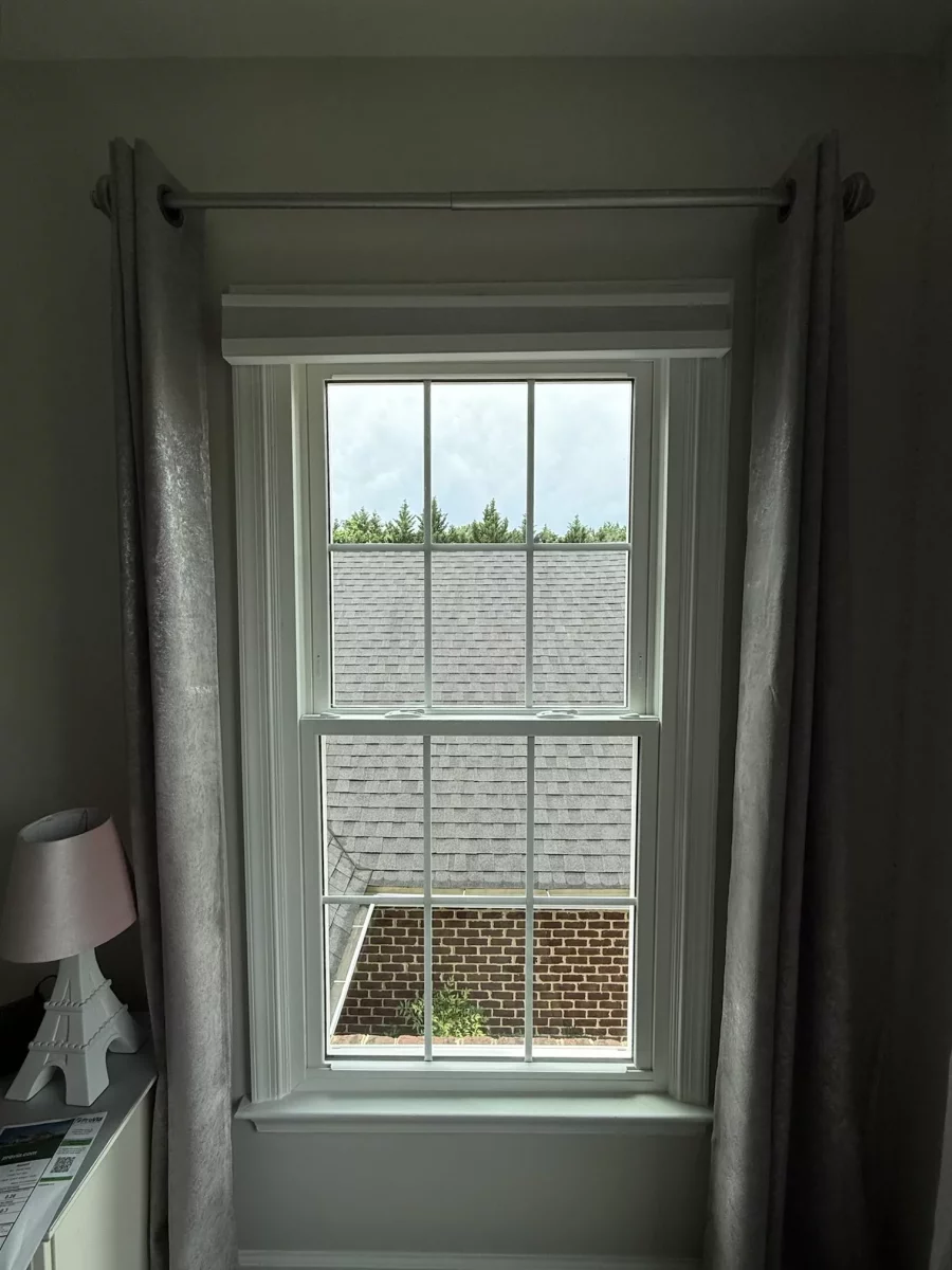 Energy-efficient double-hung window replacement in Rockville, MD, with grids and professionally finished interior trim.