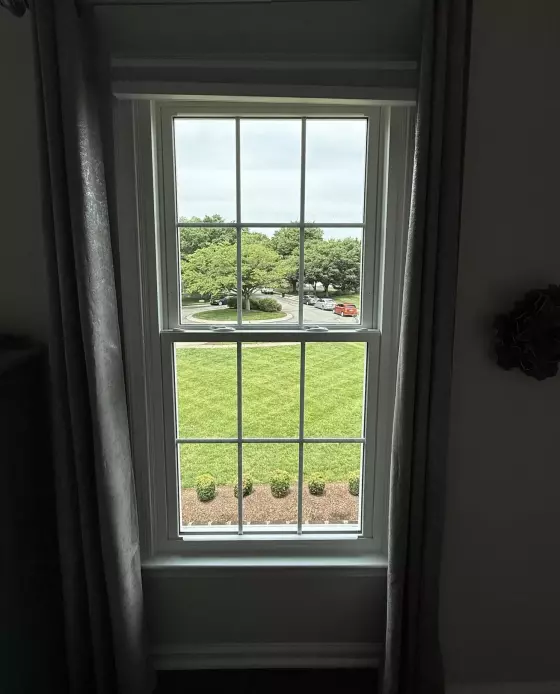Energy-efficient double-hung window replacement in Rockville, MD, with grids and professionally finished interior trim.