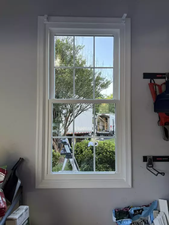 Energy-efficient double-hung window replacement in Rockville, MD, with grids and professionally finished interior trim