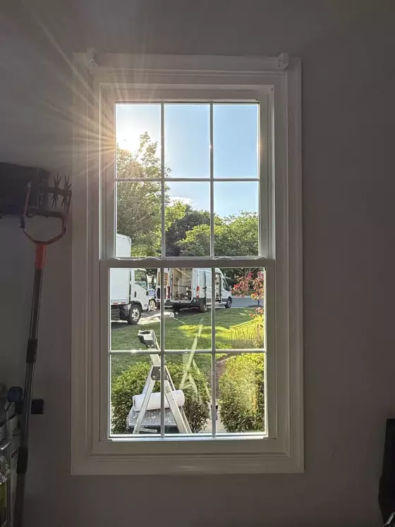Energy-efficient double-hung window replacement in Rockville, MD, with grids and professionally finished interior trim