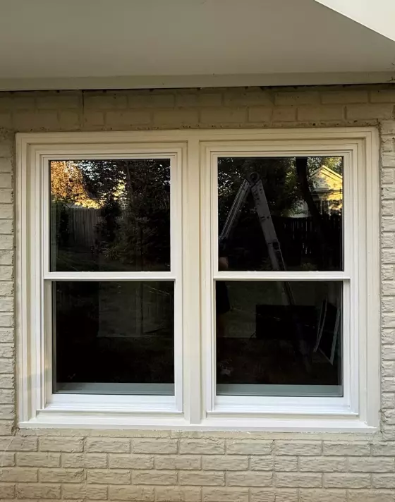 Completed full-frame double-hung window replacement with clean white exterior trim in Rockville, MD.