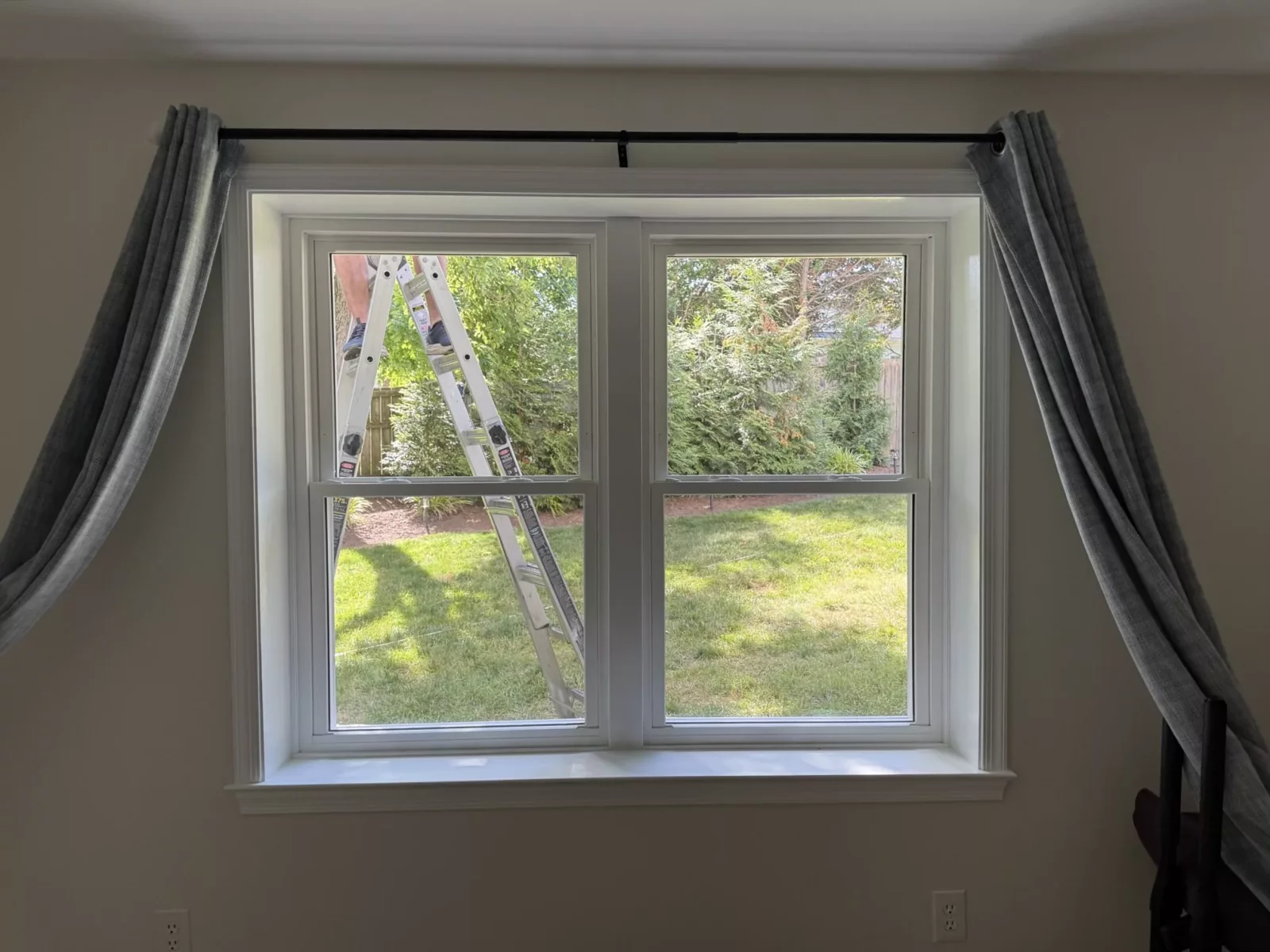 Two newly installed double-hung replacement windows with clean interior trim in Rockville, MD.