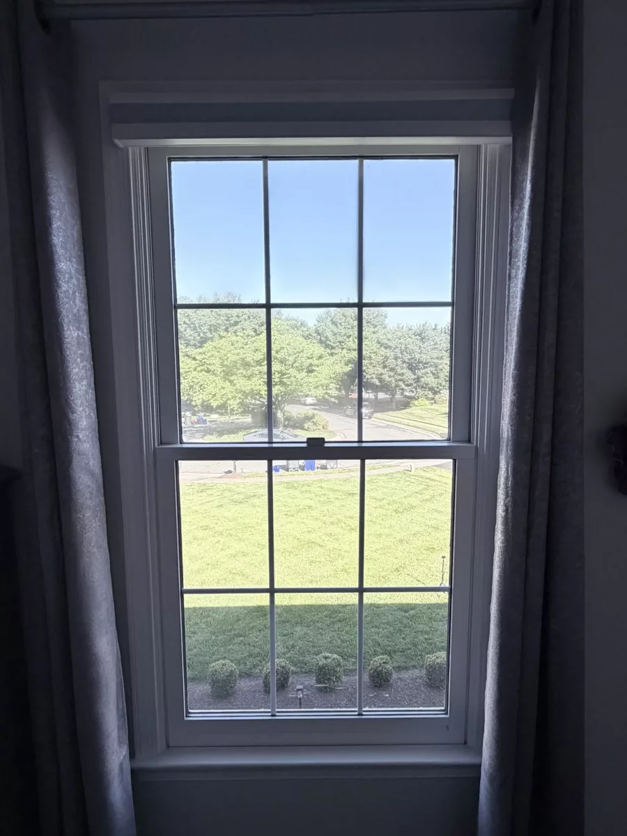 Double-hung window with grid pattern viewed from inside a room
