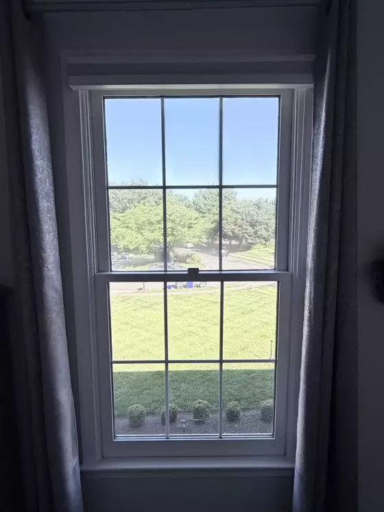 Double-hung window with grid pattern viewed from inside a room