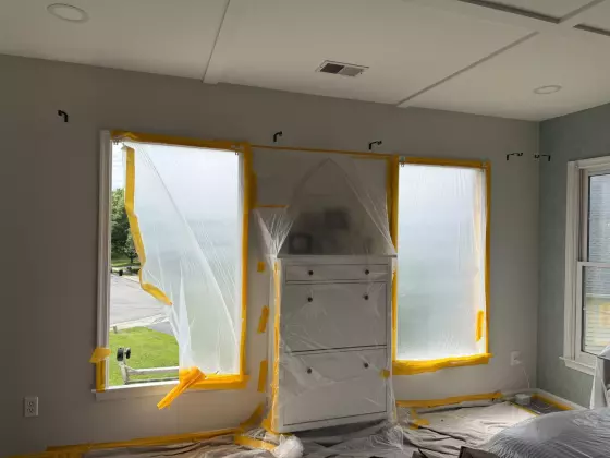 Windows covered with protective film and tape during interior work