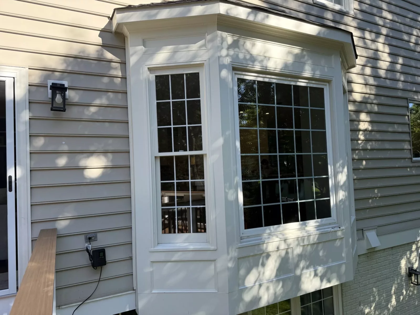 Before window replacement showing the original bay windows and exterior trim on a home in Rockville, Maryland.
