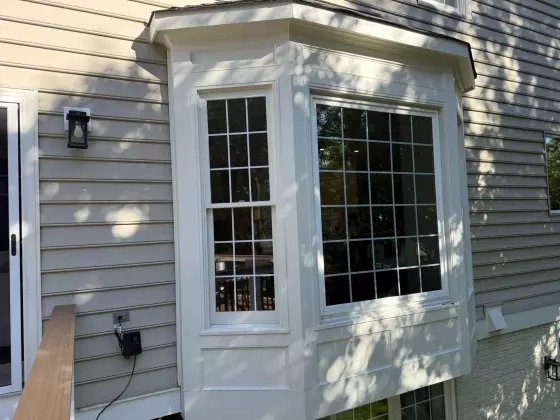Before window replacement showing the original bay windows and exterior trim on a home in Rockville, Maryland.