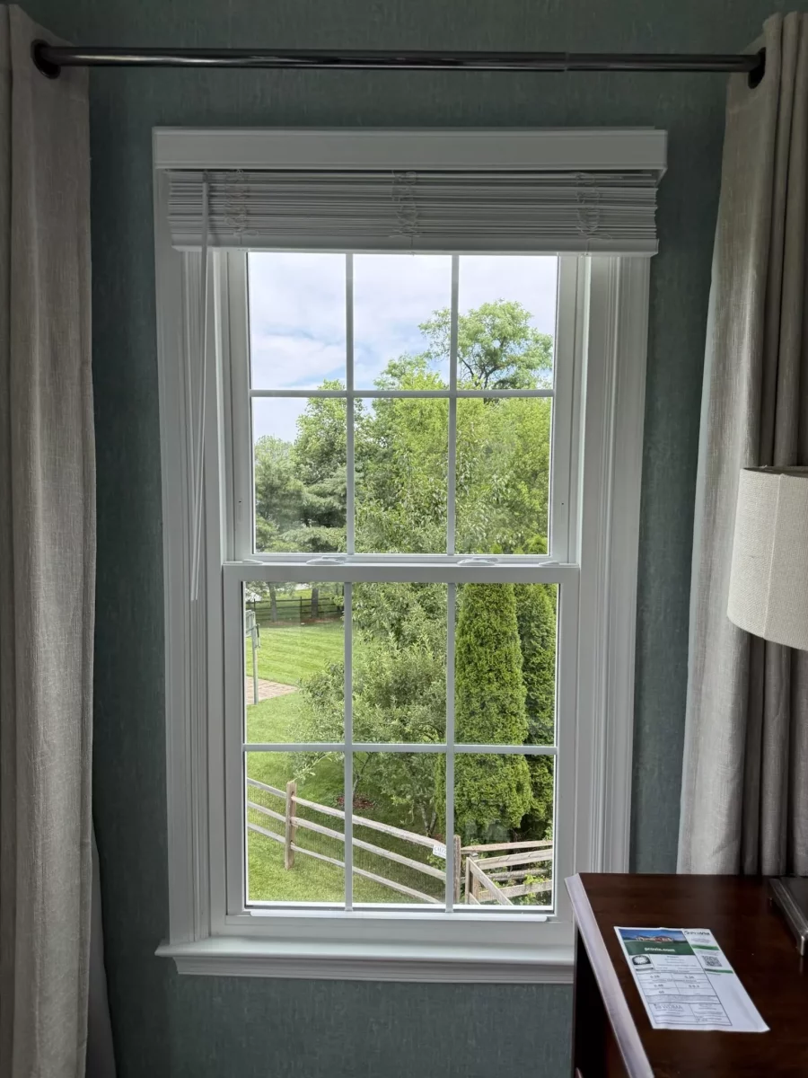 Energy-efficient double-hung window replacement in Rockville, MD, with grids and professionally finished interior trim.