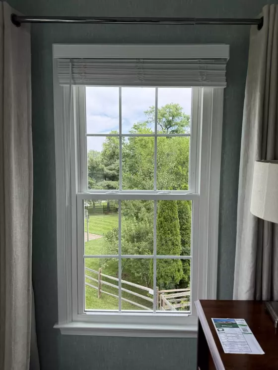 Energy-efficient double-hung window replacement in Rockville, MD, with grids and professionally finished interior trim.