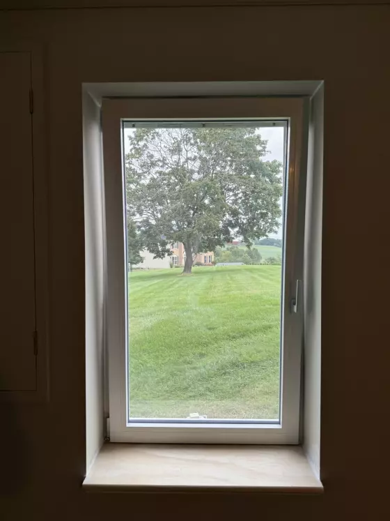 Single window with white frame and sill viewed from inside