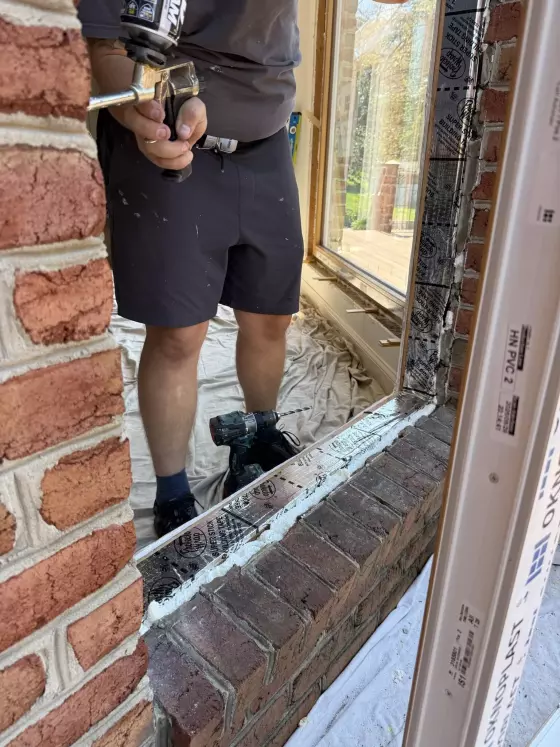 Oknoplast window installation showing protective flashing tape and spray foam insulation in Monrovia, Maryland