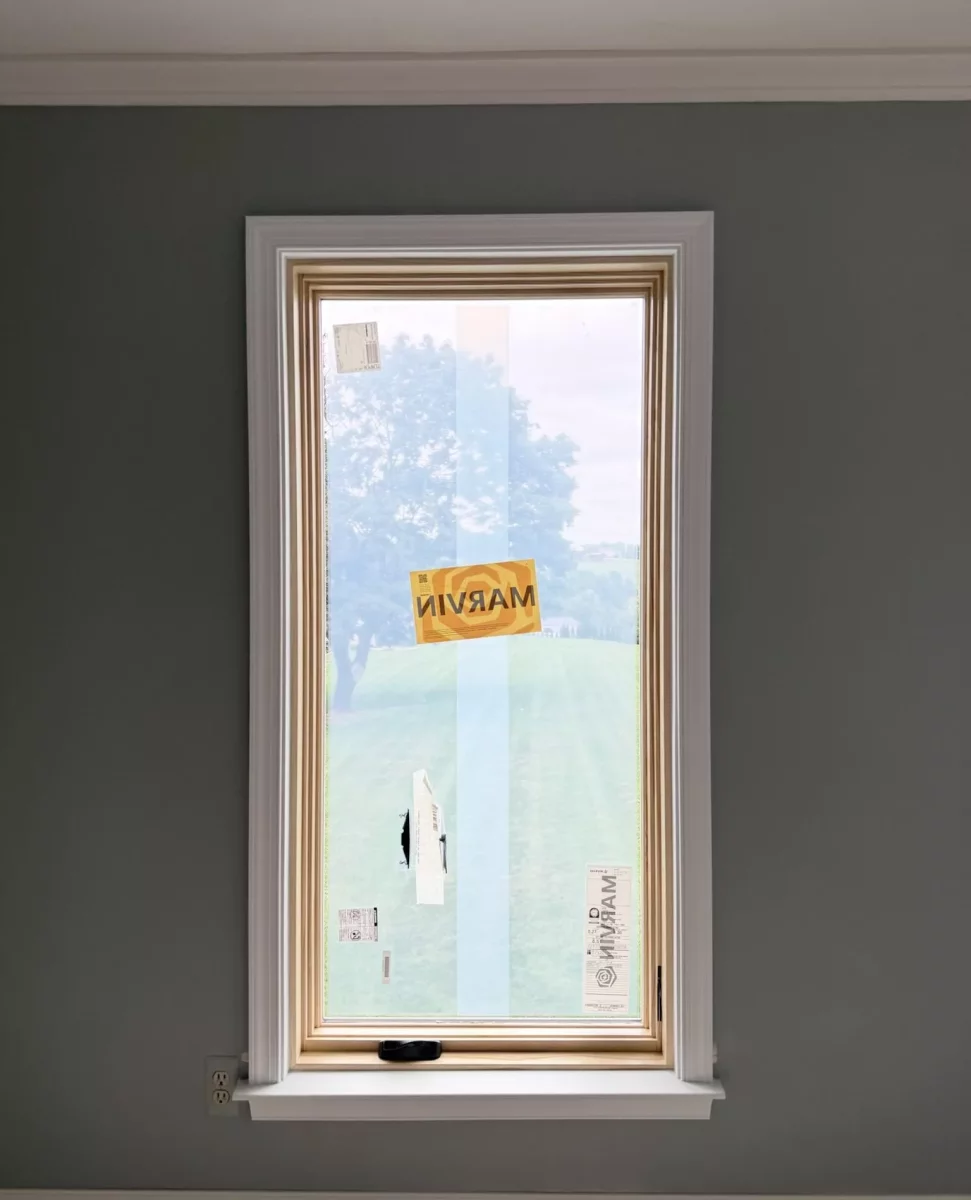New Marvin Elevate window installed with full-frame replacement and natural wood interior finish.