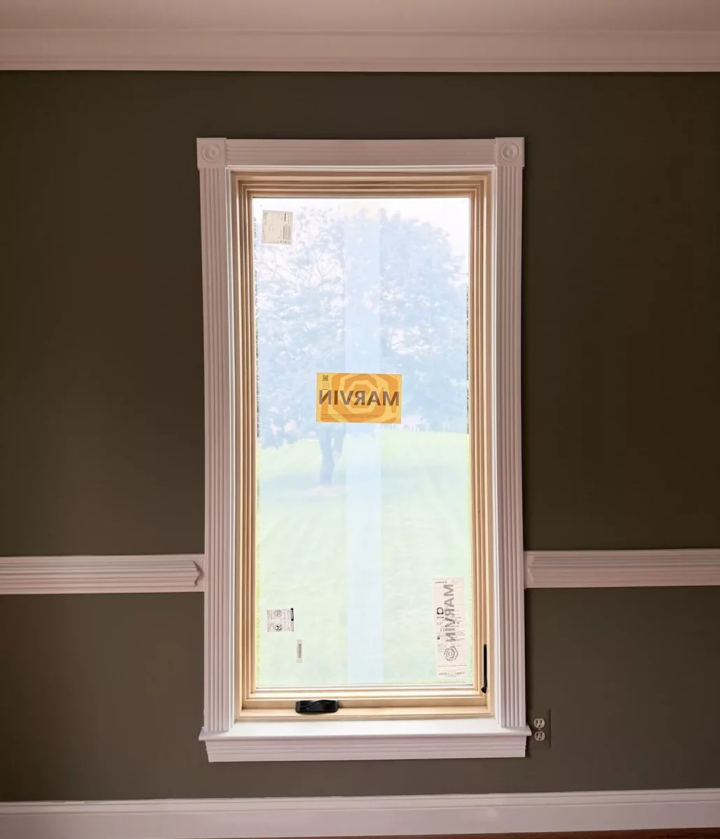 New Marvin Elevate window after full-frame replacement with natural wood interior and finished white trim.