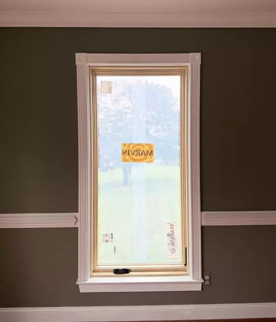 New Marvin Elevate window after full-frame replacement with natural wood interior and finished white trim.