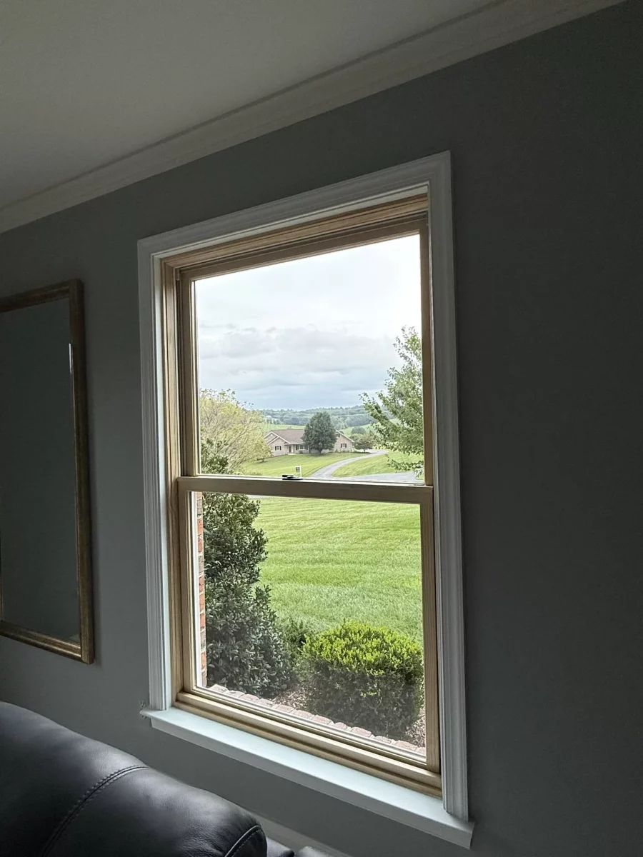 Interior view of a single window with trim and sill