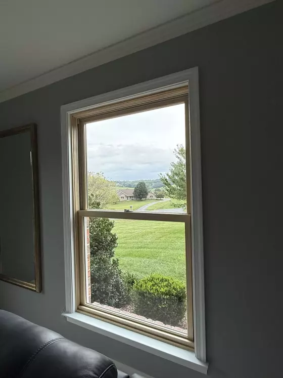 Interior view of a single window with trim and sill